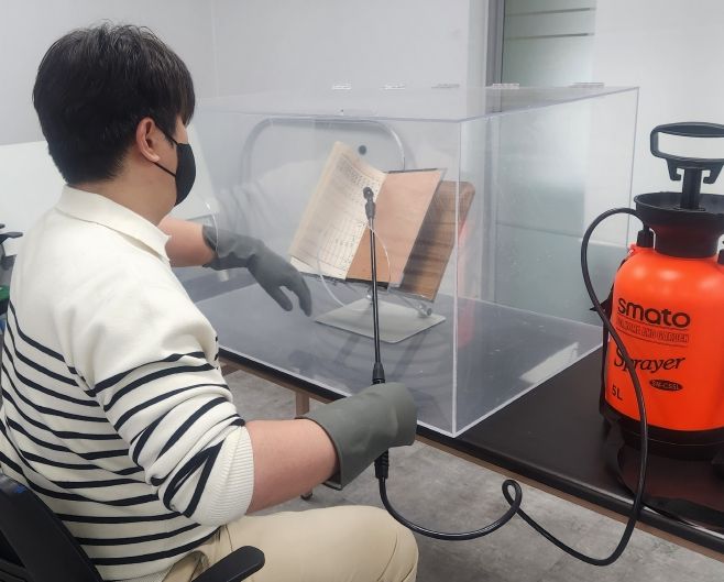 국기원이 오래된 품‧단증 발급대장 등 심사 기록물을 전산화함으로써 기록물 관리체계를 개선했다. 사진은 기록물의 탈산 처리 모습