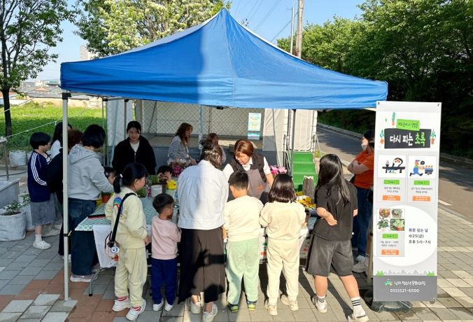 폐화분에 초록 식물을 심는 청소년