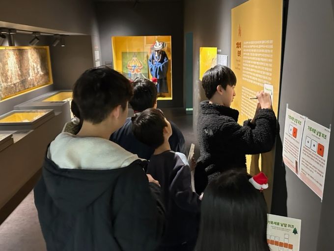 밀양시립박물관이 진행한 별을 찾는 아이들: 박물관의 크리스마스 정원 행사에서 아동들이 유물 낱말 퀴즈를 맞추고 있다.